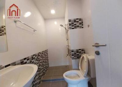 Bathroom with modern fixtures and tile accents