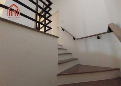 Modern staircase with wooden steps and metal railings