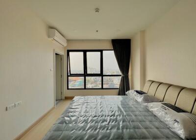 Modern bedroom with large window and city view