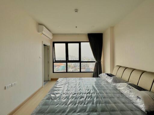 Modern bedroom with large window and city view