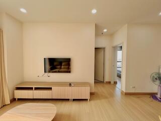 Contemporary living room with wooden furniture and wall-mounted TV