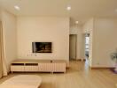 Contemporary living room with wooden furniture and wall-mounted TV