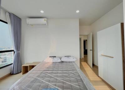 Modern bedroom with a bed, air conditioner, and wardrobe