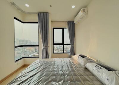 Modern bedroom with large windows and city view