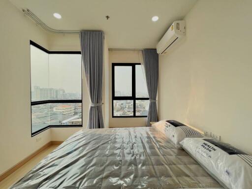 Modern bedroom with large windows and city view