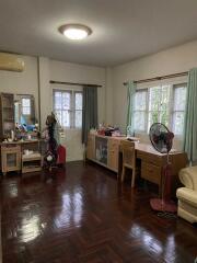 Bedroom with hardwood floors and furniture