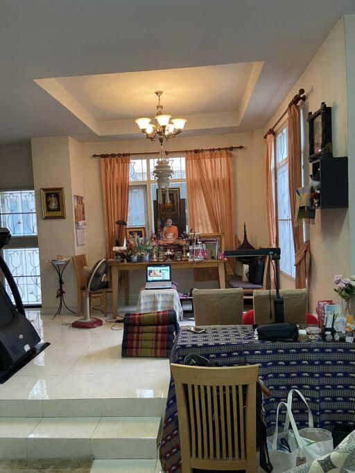 Well-lit living room with various decor items and a dining table