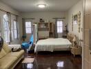 Bedroom with bed, couch, and wooden flooring