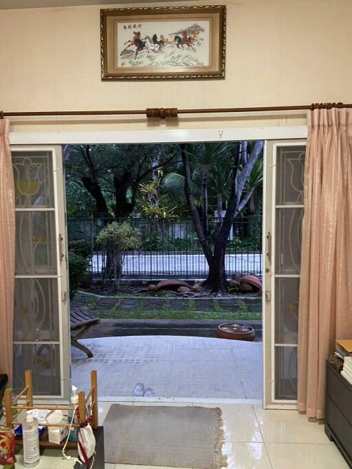 Living room with open view to a patio and garden