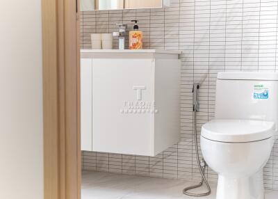 Modern bathroom with white fixtures and tiled walls