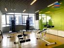 Modern gym with exercise equipment and large windows