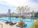 Rooftop swimming pool with lounge chairs and city skyline view