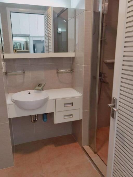 Modern bathroom with sink, mirror, and shower