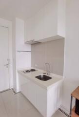 Minimalist kitchen with white cabinetry and modern fixtures