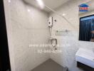 A modern bathroom with white tiled walls, a wall-mounted water heater, and a sink with a mirror