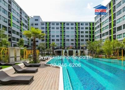 Modern apartment complex with swimming pool and sun loungers