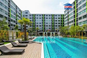 Modern apartment complex with swimming pool and sun loungers