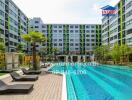 Modern apartment complex with swimming pool and sun loungers