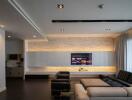 Modern living room with wall-mounted TV and sectional sofa