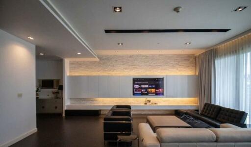 Modern living room with wall-mounted TV and sectional sofa