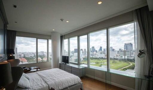 Spacious bedroom with large windows and city view