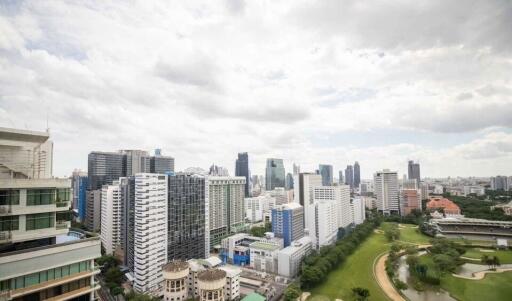 Panoramic view of a city skyline with buildings and a park