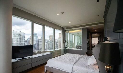 Spacious bedroom with large windows and city view