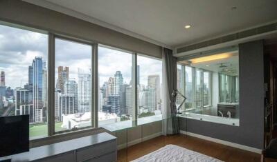 Bedroom with large windows and city view