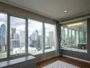 Bedroom with large windows and city view