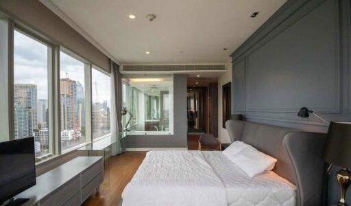 Spacious modern bedroom with large windows and city view