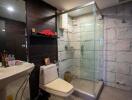 Modern bathroom with glass shower and dark wood accents