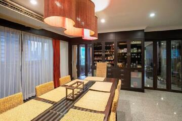 Elegant dining room with wicker chairs and large pendant lights