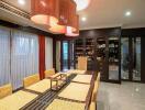 Elegant dining room with wicker chairs and large pendant lights