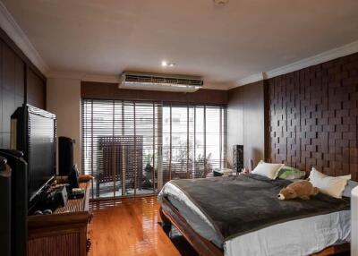 Spacious bedroom with large window and modern decor