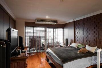 Spacious bedroom with large window and modern decor