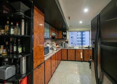 Modern kitchen with wooden cabinets, appliances, and a large refrigerator