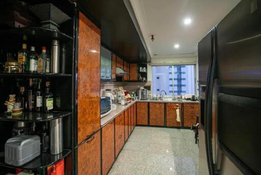 Modern kitchen with wooden cabinets, appliances, and a large refrigerator