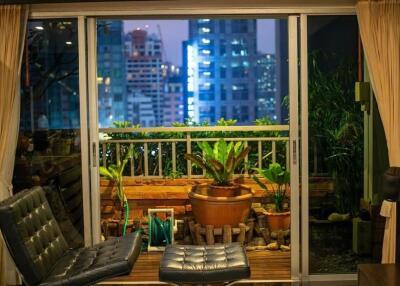 Living room with sliding doors opening to a balcony at night