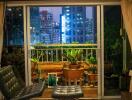 Living room with sliding doors opening to a balcony at night