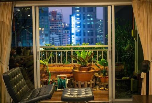 Living room with sliding doors opening to a balcony at night