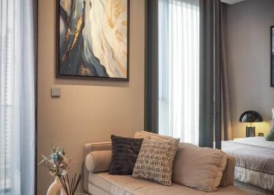 Modern living area with a beige sofa and glass coffee table