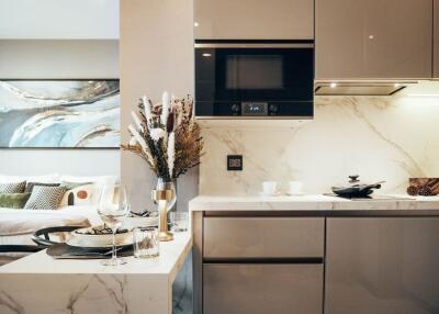 Modern kitchen with marble countertops and integrated appliances