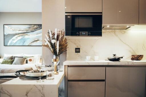 Modern kitchen with marble countertops and integrated appliances