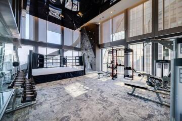 Spacious gym with boxing ring and exercise equipment