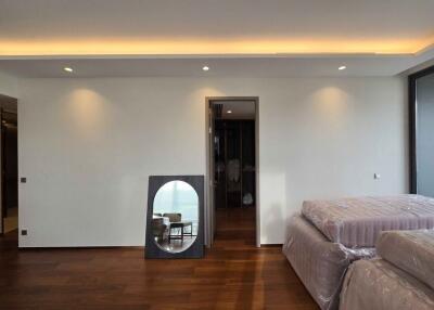 Modern bedroom with wooden floor and ambient lighting