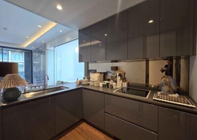 Modern kitchen with cabinets, sink, induction cooktop, and decorative items