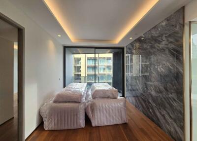 Modern bedroom with large windows and wooden flooring