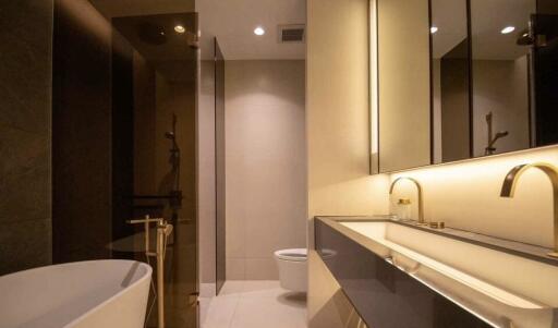 Modern bathroom with bathtub, vanity, and toilet