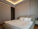 Spacious modern bedroom with double bed and built-in shelves