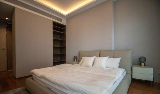 Spacious modern bedroom with double bed and built-in shelves